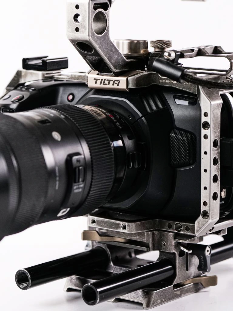 A Blackmagic Pocket cinema rig, caged and accessorized, on the bench at Simon's.