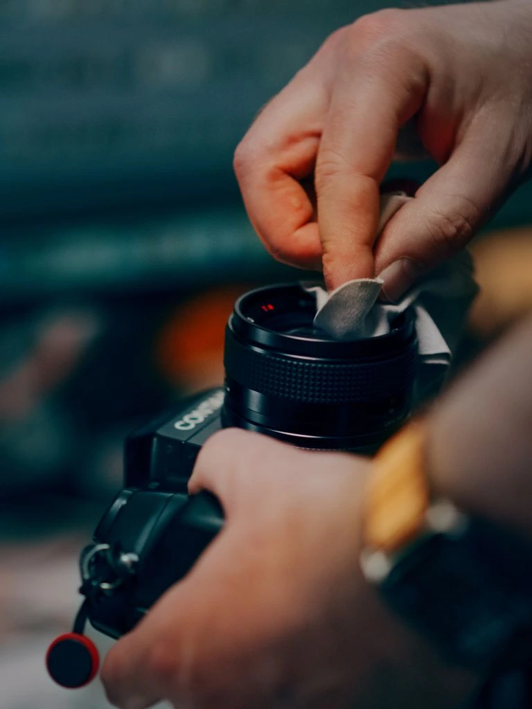 Contax T2 titanium 35mm film camera, black finish, on a marble counter.
